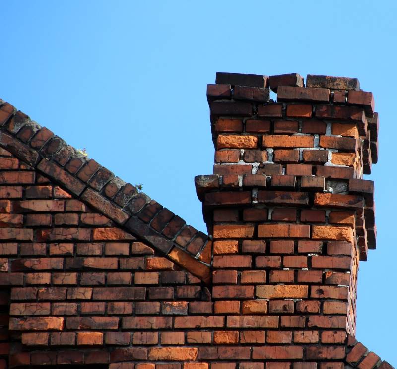 Signs Your Grafton Home Needs a Chimney Inspection Damaged chimney on an Grafton home showing cracks and missing mortar